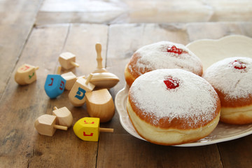 image of jewish holiday Hanukkah background with traditional spinnig top and doughnuts.