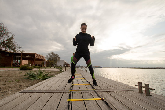 young woman athlete training outdoor in cold weather  