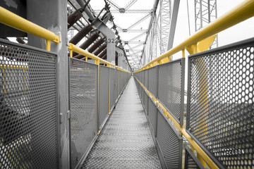 yellow railing of a transportation bridge
