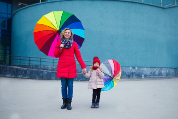 happy mother and daughter colorful umbrellas