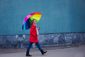 happy woman with colorful umbrella walking