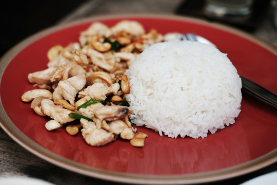 Rice topped with stir-fried chicken and basil