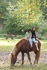 Foto op Canvas Two girls with horse © jeancliclac