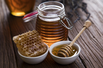 Jar full of fresh honey and honeycombs
