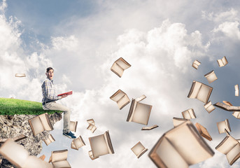 Man reading book and many of them flying in air