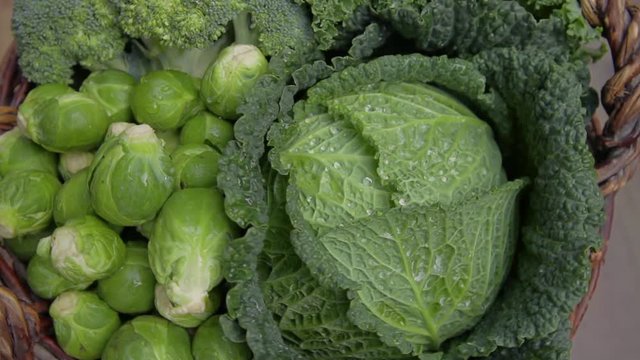 various green cabbages in basked rotating on daylight Seasonal Vegetables 