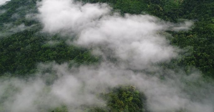 Aerial View. Flying over the beautiful mountain in clouds.