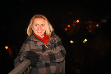 Night portrait blonde girl in a warm coat