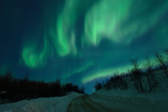 Aurora,Northern lights over the hills and road.