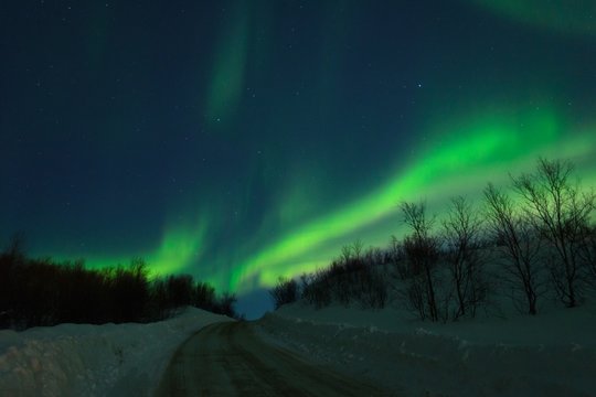 Aurora,Northern lights over the hills and road.