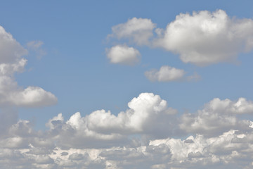 clouds scattered in a blue sky
