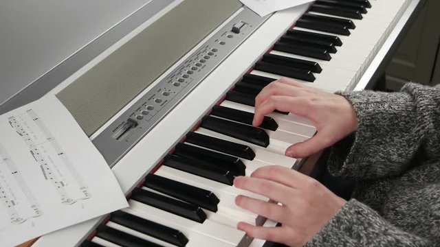 girl at home rehearsing on electronic piano