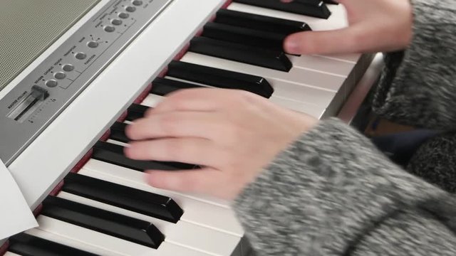 girl at home rehearsing on electronic piano