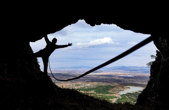 climbing with rope in the cave