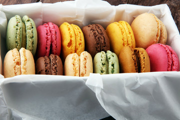 Different types of macaroons or macarons in a box.
