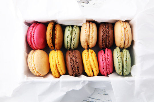 Different types of macaroons or macarons in a box.