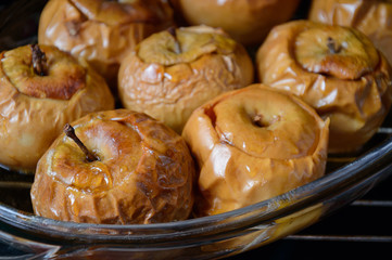 Juicy ripe apples are baked in the oven with honey in autumn