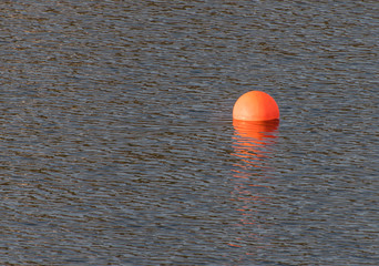 orange buoy in the sea at the faroe islands