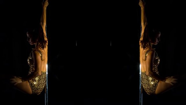 amazing pole dancer showing her skills against a black background using stop motion