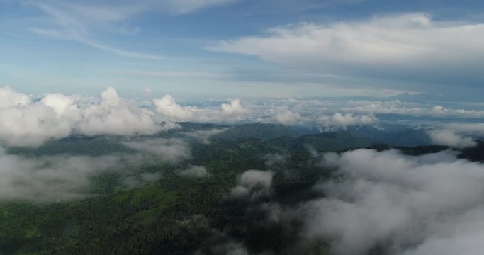 Aerial View. Flying over the beautiful mountain in clouds.