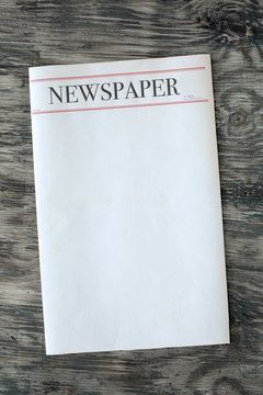 Mock up newspaper on wooden background