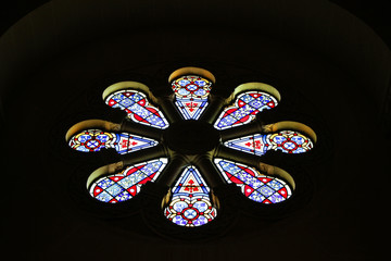 stained glass church window in darkness 