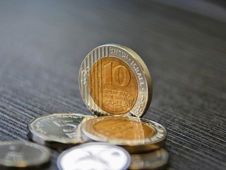 New Israeli Shekel coins on the table