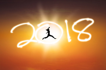 Young woman jumping with number 2018