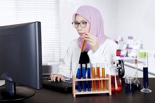 Young scientist using computer in the lab