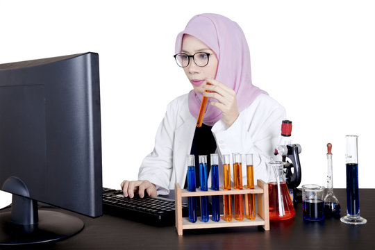 Young muslim scientist works with computer