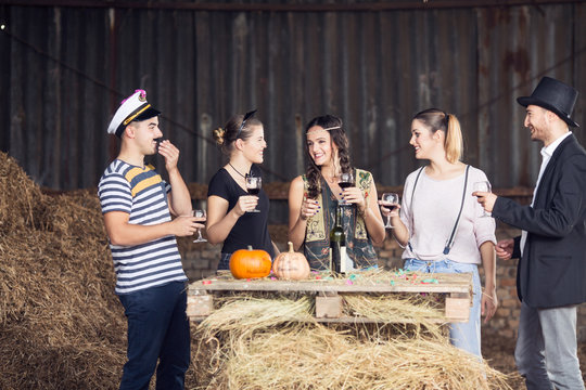Group of adults drinking and having fun on halloween party