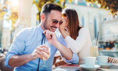 Romantic couple drinking coffee and lemonade, having a date in the cafe. Dating, love, relationships