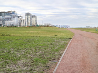 open park near the high-speed road of the cloud in the autumn morning, green grass path