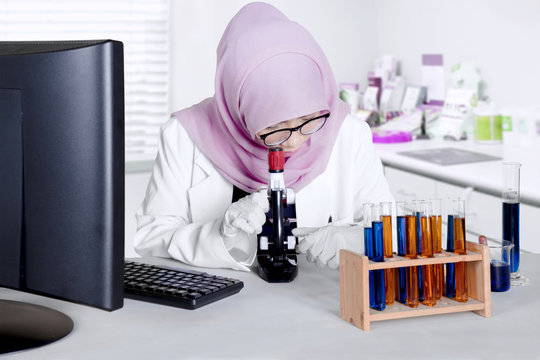 Scientist analyze chemical with microscope