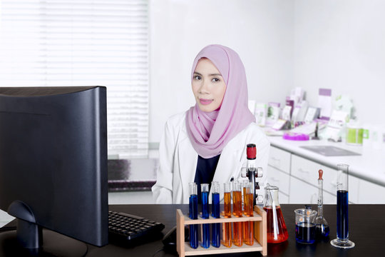 Muslim scientist smiling at camera
