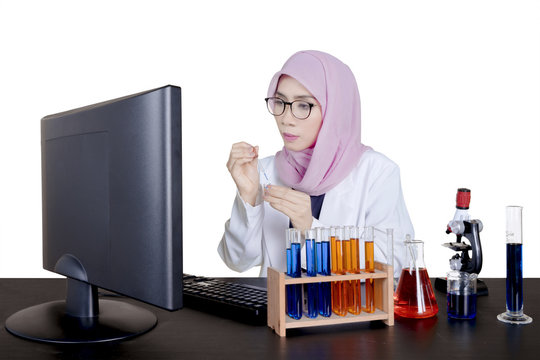 Muslim female scientist working on desk