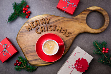 Christmas background with cookies, coffee cup, gift box and fir tree. Top view