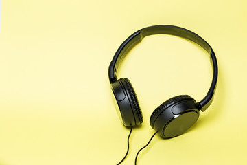 Fototapeta na wymiar headphones black on a yellow background