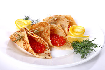 Three pancakes filled with the salmon caviar