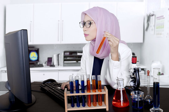 Asian muslim scientist works in the lab