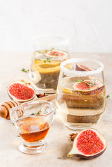 Fall cold sweet white wine cocktail with fig, plum, honey and thyme, copy space