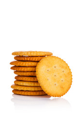 Round cheese crackers with salt on white