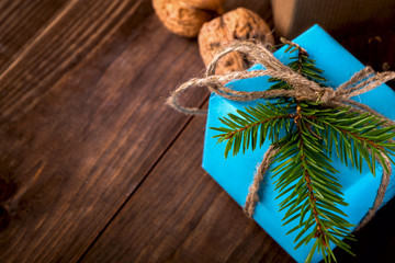 Christmas Happy New Year Holiday Composition with box, cone and walnut on a Wooden Background.