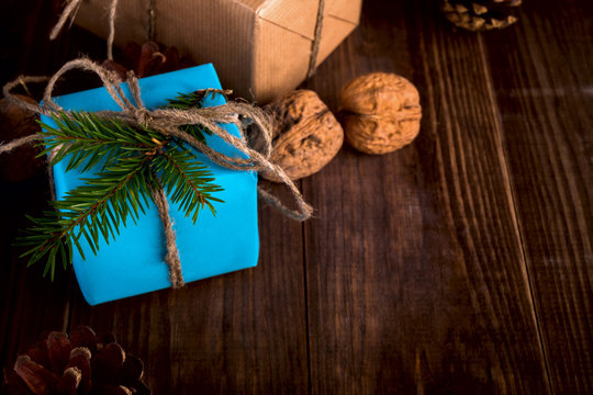 Christmas Happy New Year Holiday Composition with box, cone and walnut on a Wooden Background.