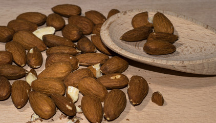 Almond composition, wooden board, spoon, side view