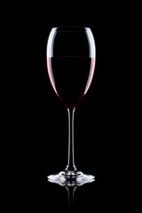 Glass of red wine on black with reflection