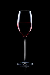 Fototapeta na wymiar Glass of red wine on black with reflection