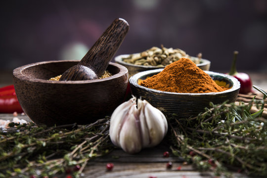 Assortment of spices in wooden bowl background 