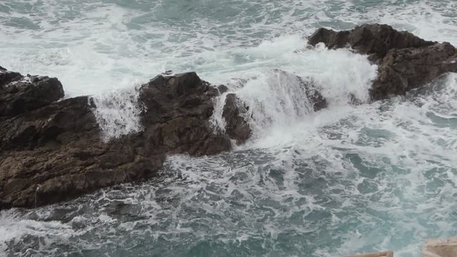Big waves hitting the rocks. Sea waves crashing on the rocks during the storm. Storm ocean waves breaking. Tidal wave