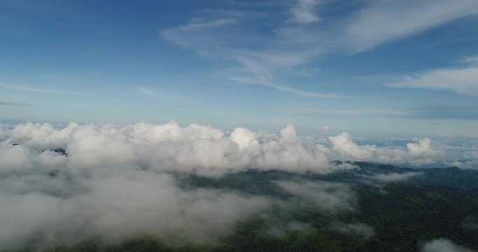 Aerial View. Flying over the beautiful mountain in clouds.